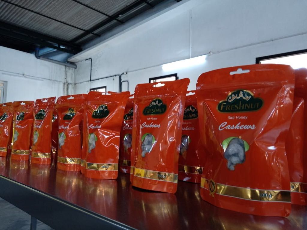 Orange Sidr Honey pouches on a factory table