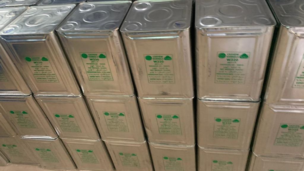 A wider stack of W320 cashew tins